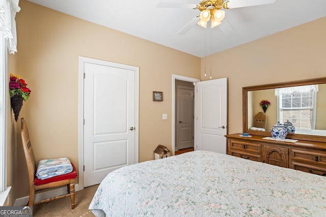 bedroom featuring light colored carpet and ceiling fan