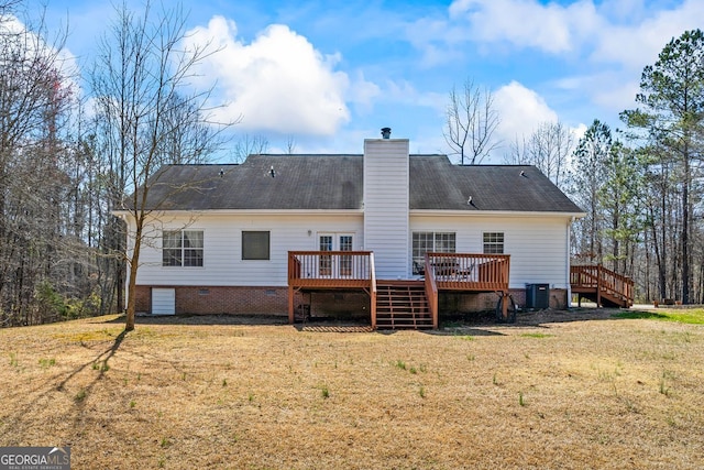 back of house with a deck, crawl space, a yard, and a chimney