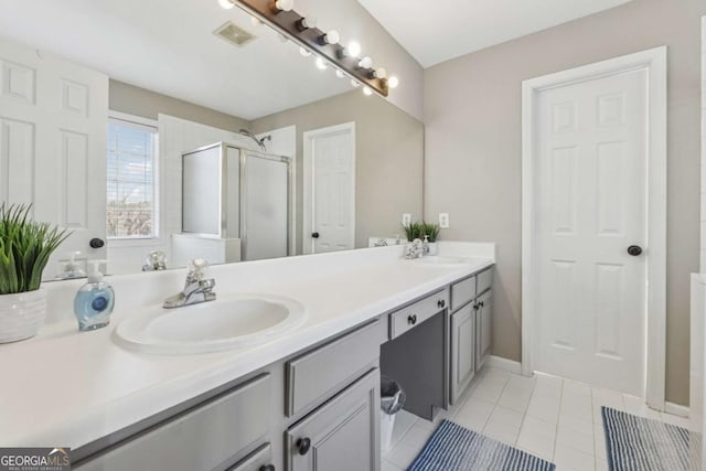 2311 Fall Creek Lndg, Loganville, GA 30052 - bathroom featuring double vanity, tile patterned floors, and a shower stall