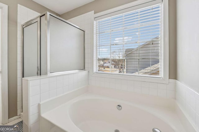 2311 Fall Creek Lndg, Loganville, GA 30052 - bathroom featuring a garden tub and a stall shower
