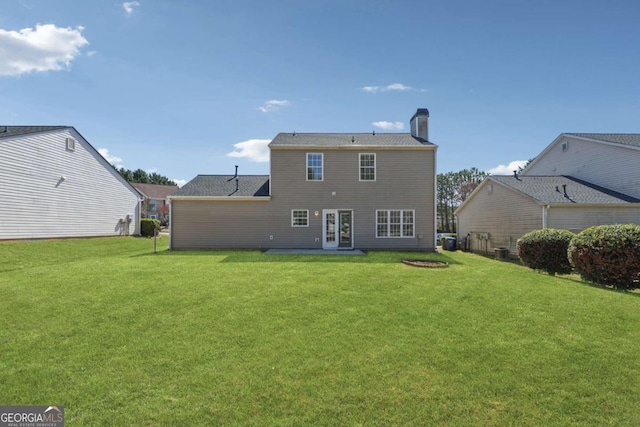 2311 Fall Creek Lndg, Loganville, GA 30052 - back of house with a yard, a chimney, french doors, and a patio area