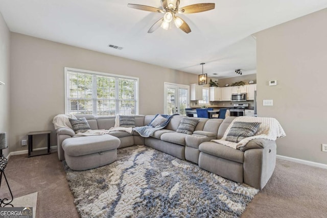 2311 Fall Creek Lndg, Loganville, GA 30052 - living room with carpet floors and a ceiling fan