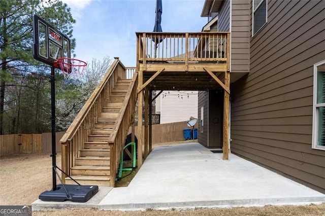 view of patio with stairway, a deck, and fence