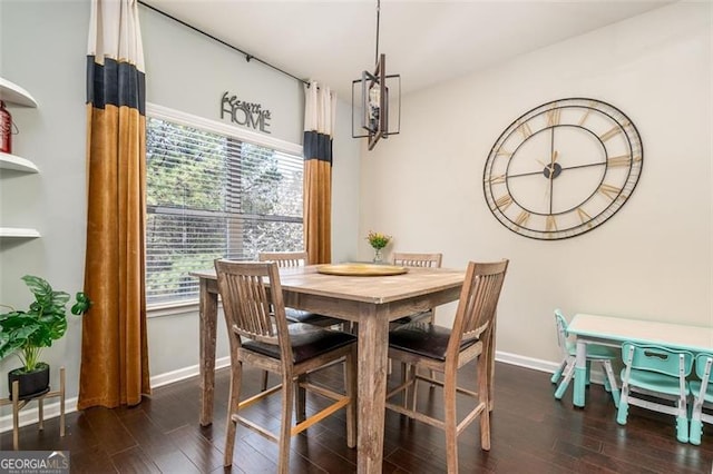 dining space with wood finished floors and baseboards