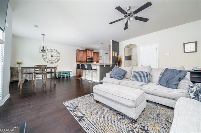 784 Sunset Down Ct, Loganville, GA 30052 - living room featuring a ceiling fan, dark wood-style flooring, arched walkways, recessed lighting, and a chandelier