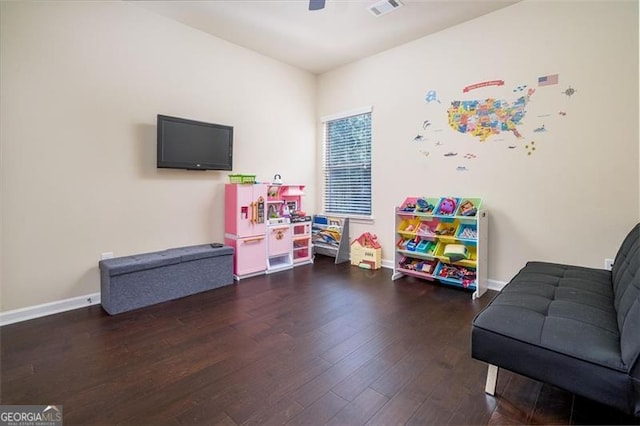 rec room with baseboards, wood finished floors, visible vents, and ceiling fan