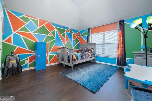 bedroom featuring wood finished floors and baseboards