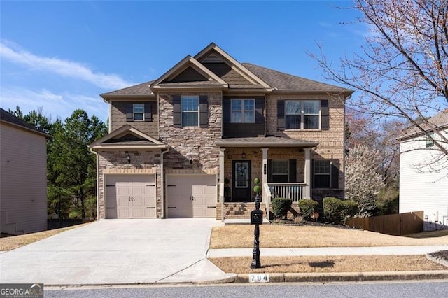 784 Sunset Down Ct, Loganville, GA 30052 - craftsman inspired home featuring covered porch, an attached garage, driveway, and stone siding
