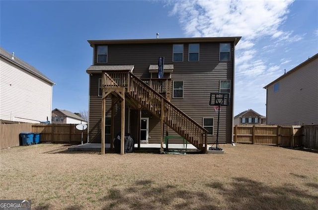 rear view of property featuring a deck, a fenced backyard, a yard, stairs, and a patio area