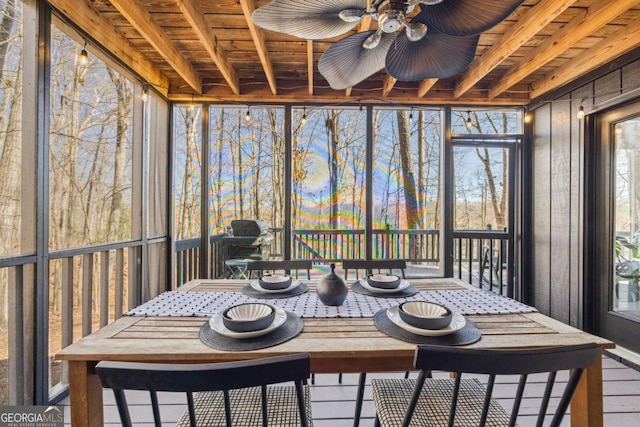 sunroom / solarium featuring beam ceiling, wood ceiling, and ceiling fan