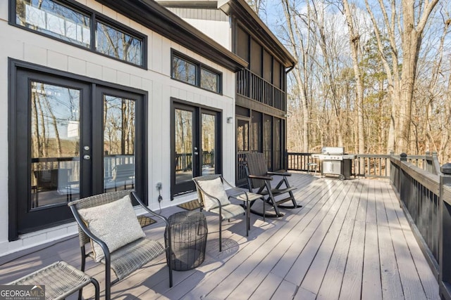 wooden terrace featuring grilling area and french doors