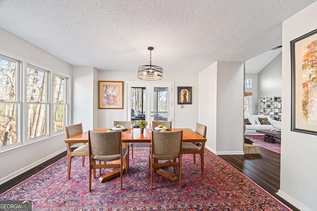 dining area with baseboards and dark wood finished floors