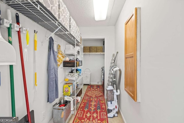 clothes washing area featuring laundry area and a textured ceiling