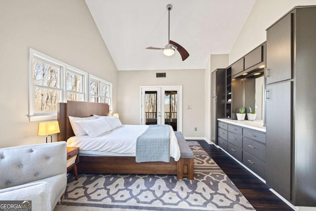 bedroom featuring visible vents, dark wood-type flooring, baseboards, french doors, and high vaulted ceiling