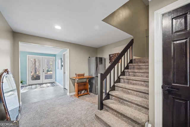 entryway with recessed lighting, french doors, baseboards, and stairway