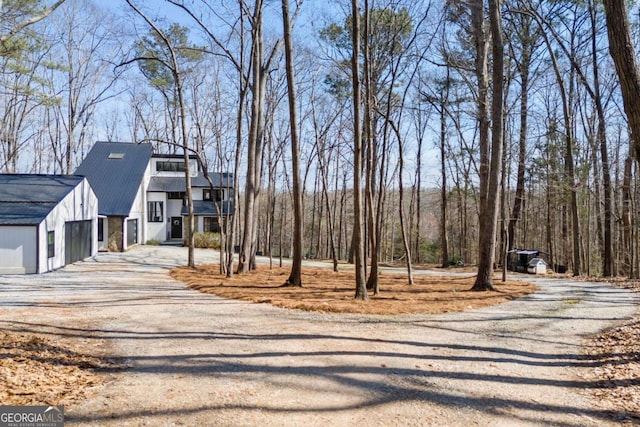 view of street with dirt driveway