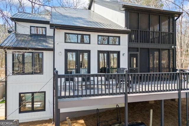 rear view of property with metal roof