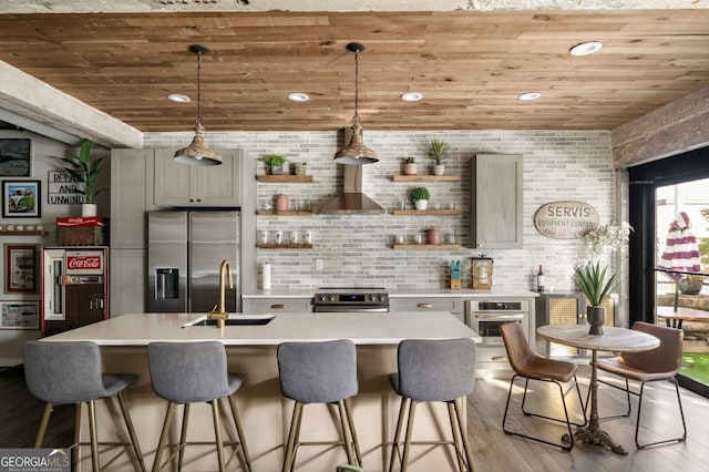 kitchen featuring open shelves, a sink, appliances with stainless steel finishes, light countertops, and wood ceiling