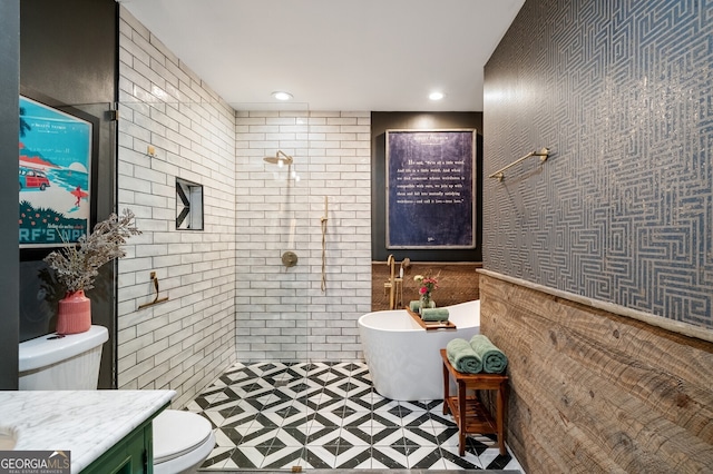 full bath featuring toilet, recessed lighting, tiled shower, a freestanding tub, and vanity