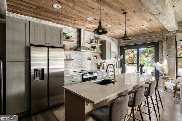 kitchen with open shelves, a sink, appliances with stainless steel finishes, wooden ceiling, and wall chimney range hood