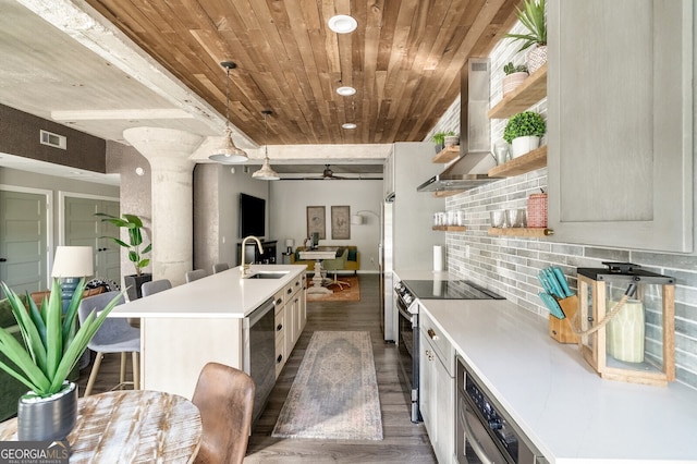 kitchen featuring open shelves, a sink, stainless steel electric range, wall chimney exhaust hood, and decorative backsplash