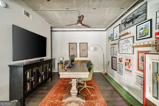 office area featuring visible vents, baseboards, wood finished floors, and a ceiling fan