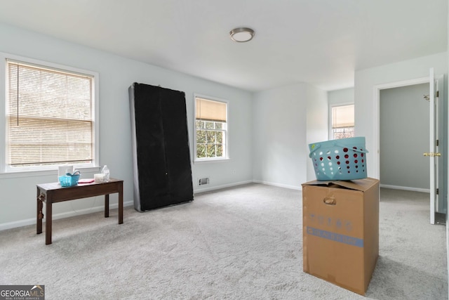 interior space with baseboards and carpet floors