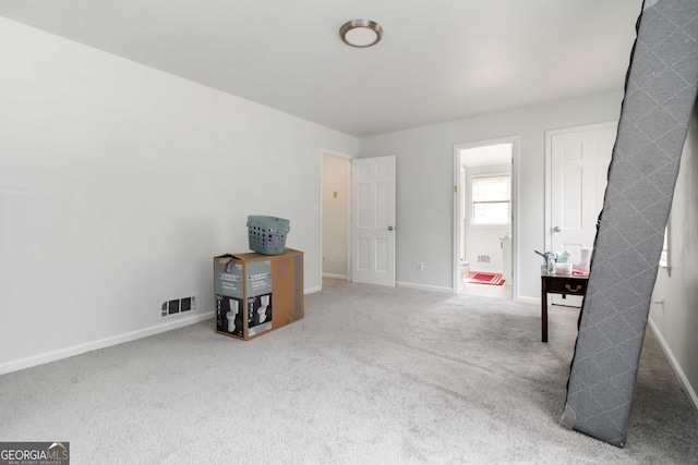 carpeted bedroom with visible vents and baseboards