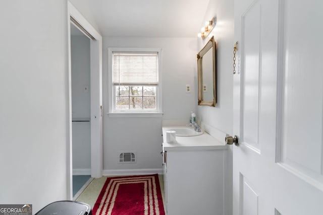 bathroom with visible vents, vanity, and baseboards