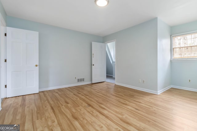 interior space featuring visible vents, baseboards, and light wood-style floors