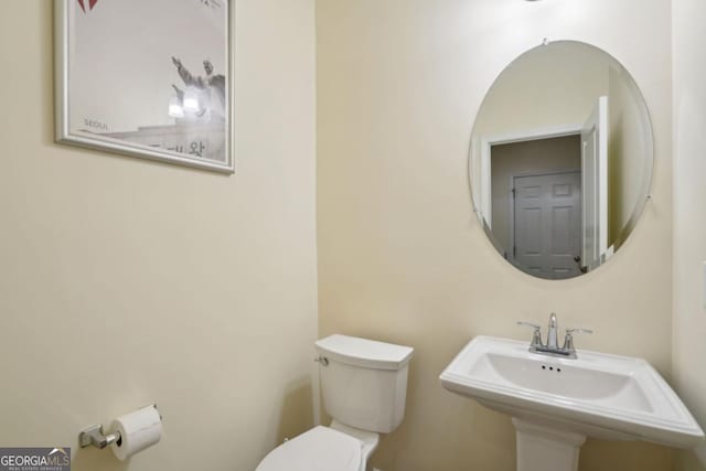 bathroom featuring toilet and a sink