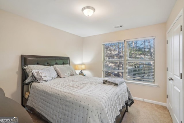 bedroom with visible vents, baseboards, and carpet flooring