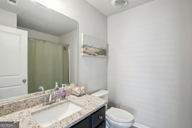 bathroom featuring visible vents, toilet, vanity, and a shower with shower curtain