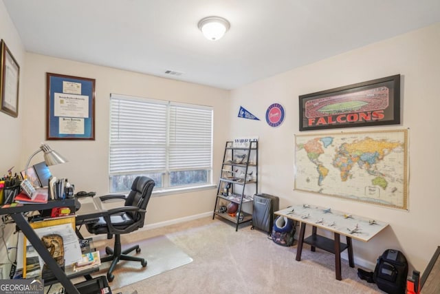 office featuring visible vents, baseboards, and light colored carpet