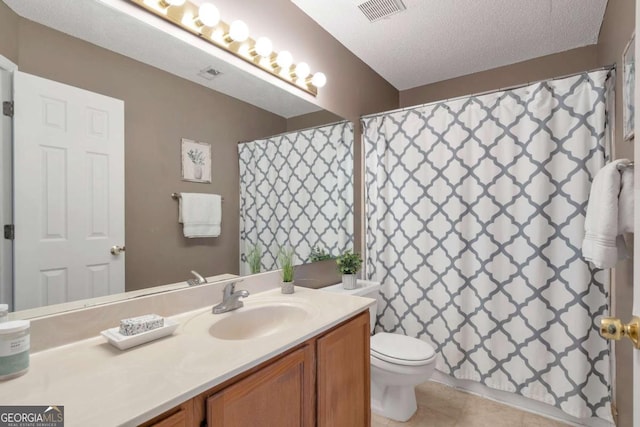 bathroom featuring visible vents, toilet, a textured ceiling, tile patterned flooring, and vanity