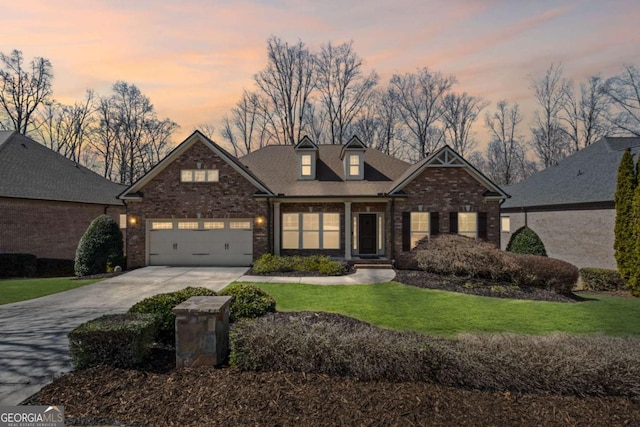 craftsman-style home featuring brick siding, driveway, an attached garage, and a front yard