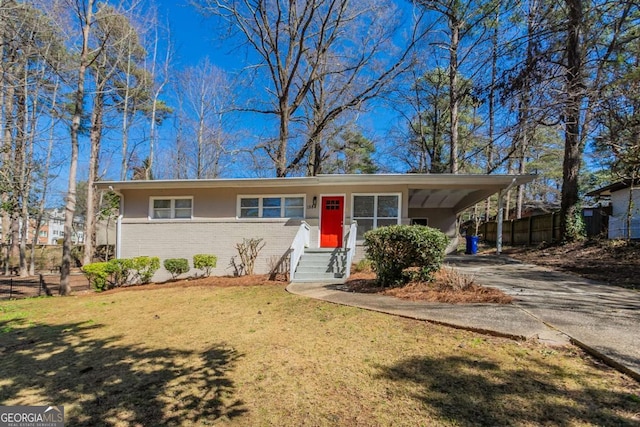 ranch-style house with a front lawn, fence, concrete driveway, an attached carport, and brick siding