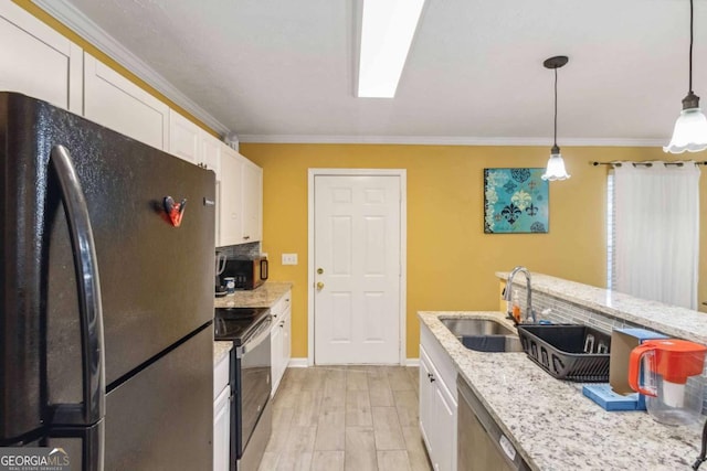 kitchen featuring light wood-style flooring, a sink, black appliances, white cabinetry, and crown molding