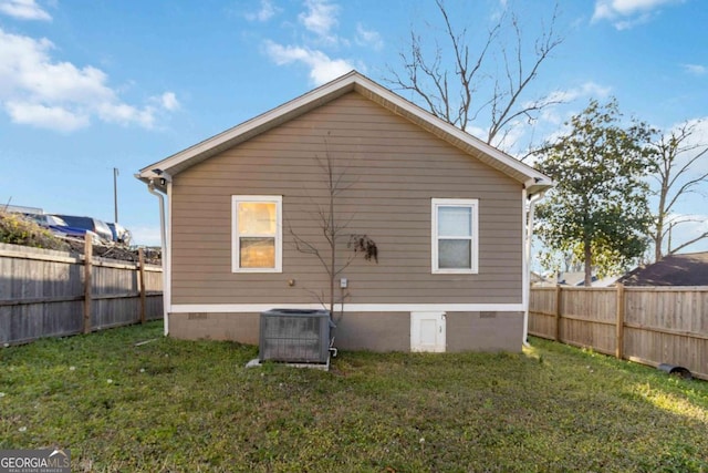 rear view of property featuring a yard, a fenced backyard, and crawl space