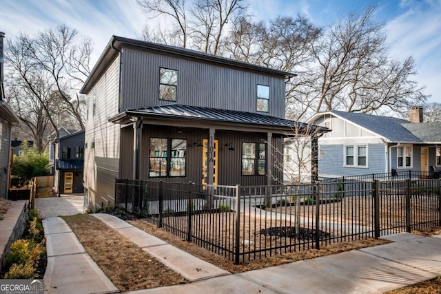 1103 Boulevard Dr SE, Atlanta, GA 30317 - view of front of house with a fenced front yard, metal roof, and a standing seam roof