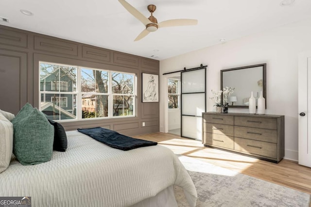 1103 Boulevard Dr SE, Atlanta, GA 30317 - bedroom featuring a decorative wall, visible vents, light wood finished floors, and ceiling fan
