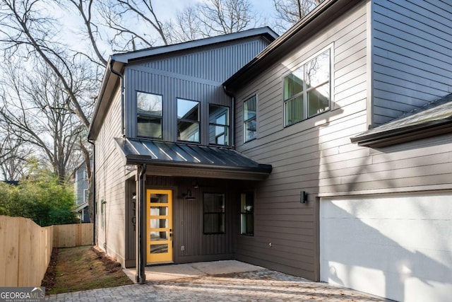 1103 Boulevard Dr SE, Atlanta, GA 30317 - view of front of property featuring board and batten siding, a garage, and fence