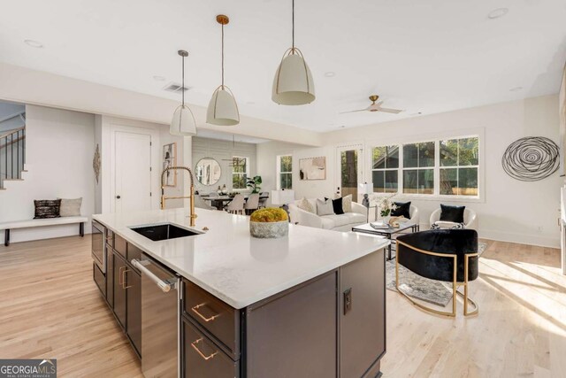 1103 Boulevard Dr SE, Atlanta, GA 30317 - kitchen with light wood-style flooring, stainless steel dishwasher, an island with sink, and a sink