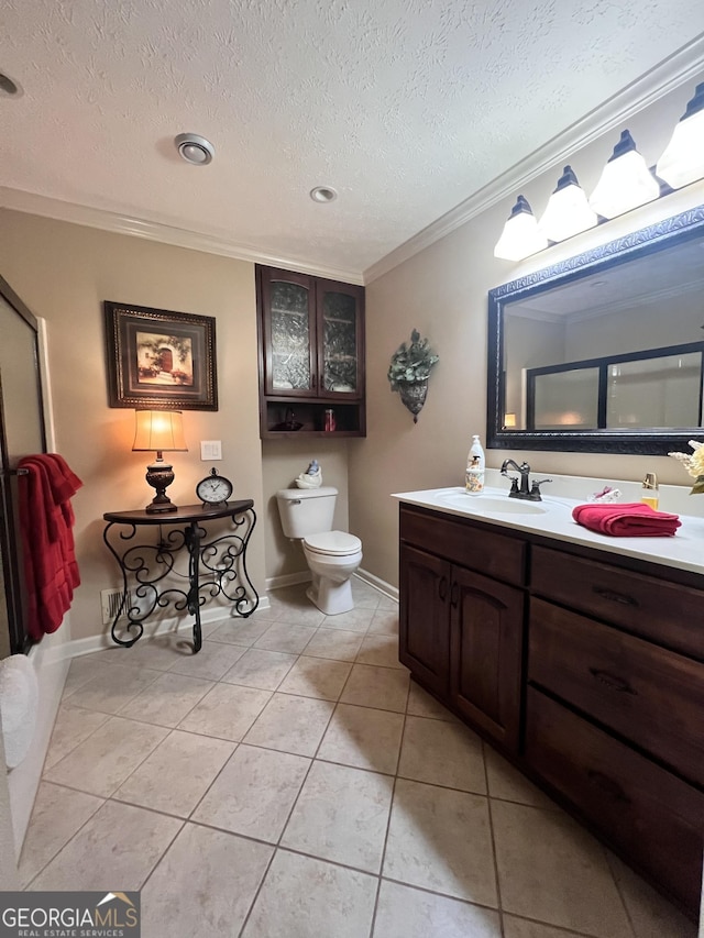 full bathroom featuring vanity, ornamental molding, a textured ceiling, tile patterned floors, and toilet