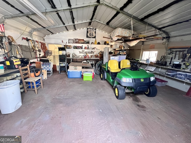 garage featuring metal wall and a workshop area