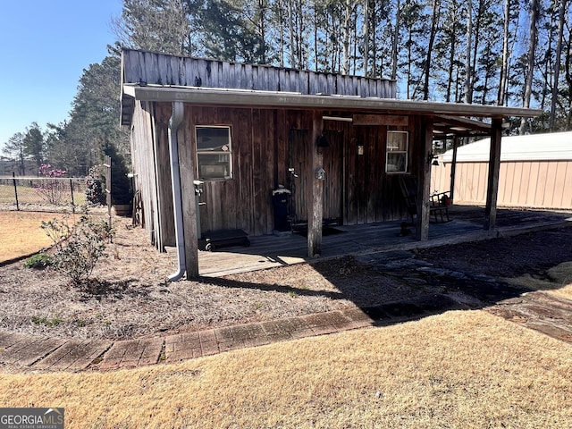 view of outbuilding featuring fence