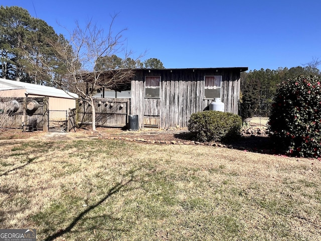 exterior space with an outdoor structure and fence