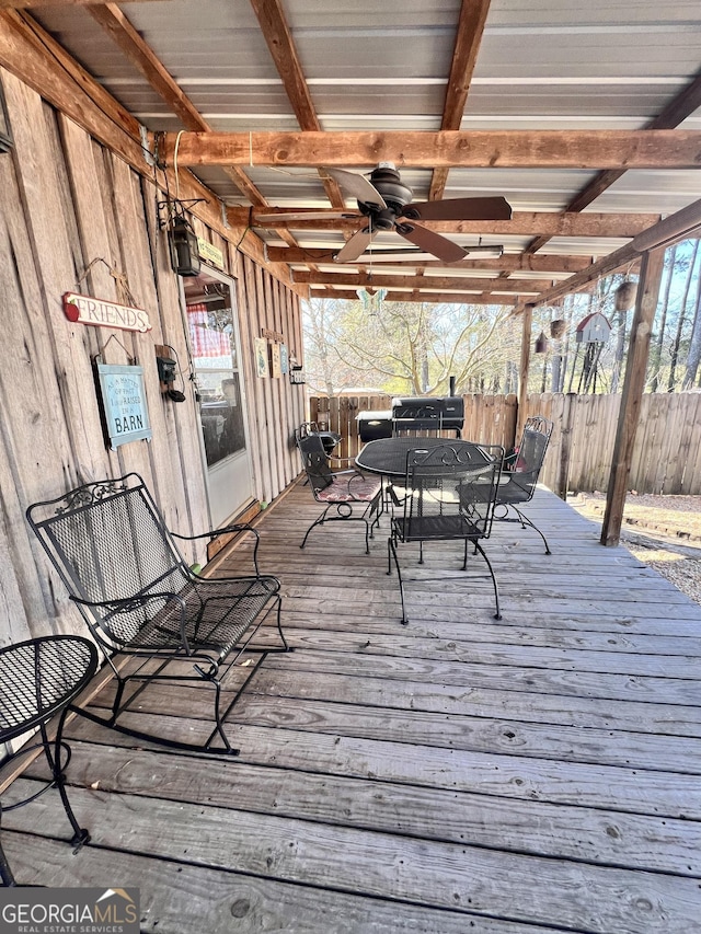 deck with outdoor dining space and fence