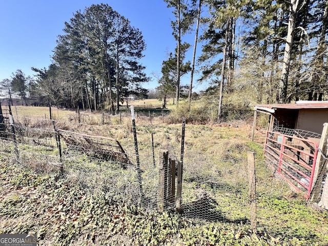 view of yard with an outbuilding and fence