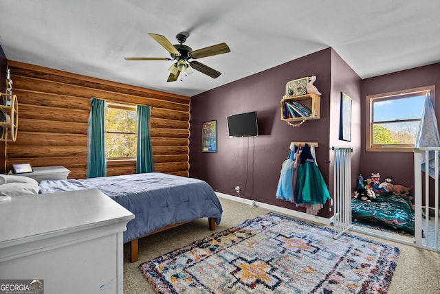 bedroom featuring rustic walls, ceiling fan, baseboards, and carpet floors